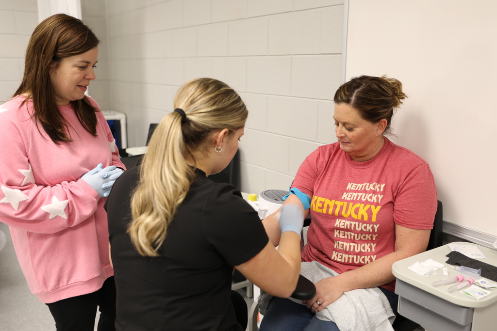 Phlebotomy Student practicing an arm IV. 