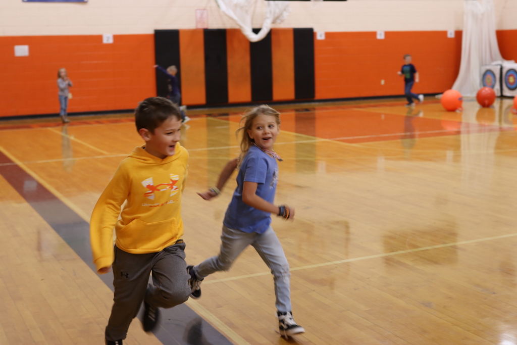 Students running in gym class