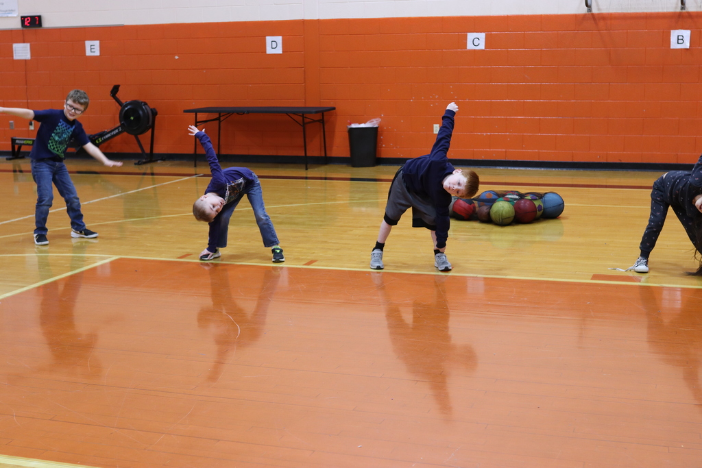 students stretching in gym class